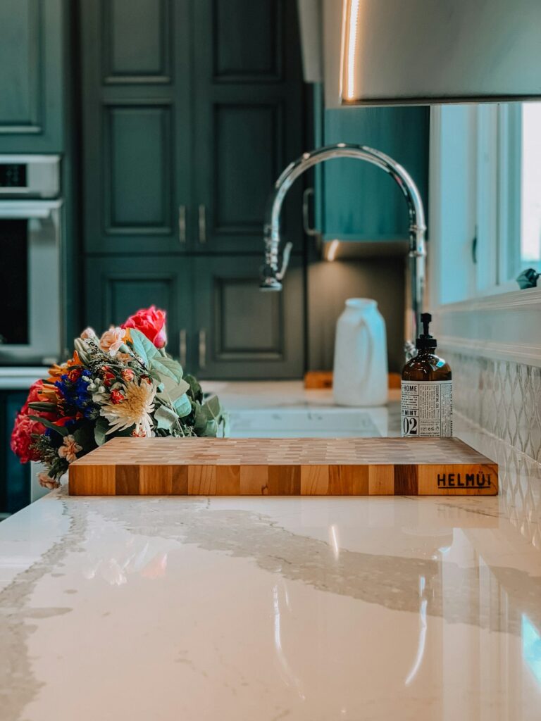 A bright kitchen with marble countertops, natural light, and subtle gray veining on the stone.